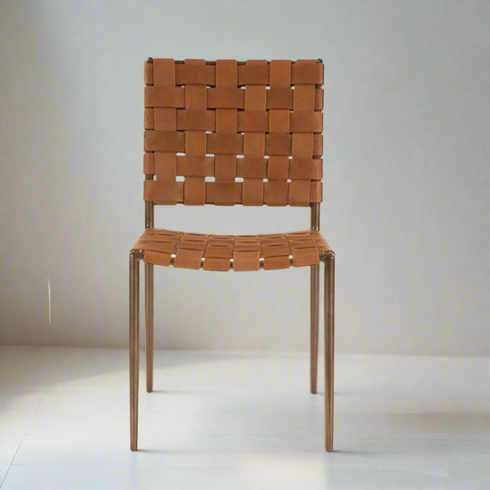 Light Brown woven chair on a white floor with a white wall background